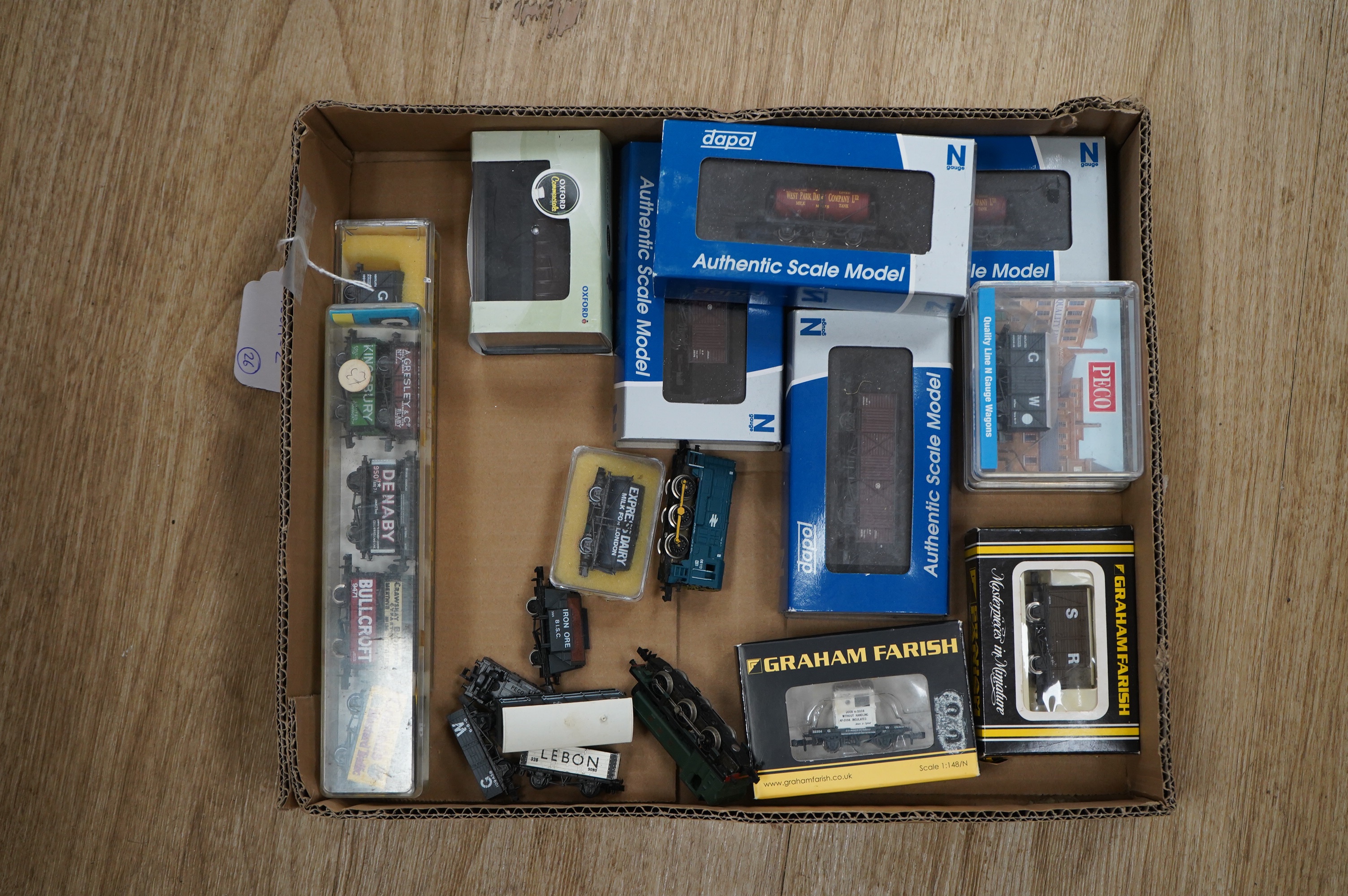 Twenty-six N gauge railway items by Dapol, Graham Farish, etc. including two locomotives, a GWR Class 94xx loco and a BR Class 08 diesel shunter, together with twenty-four freight wagons plus an Oxford Diecast Scammell M